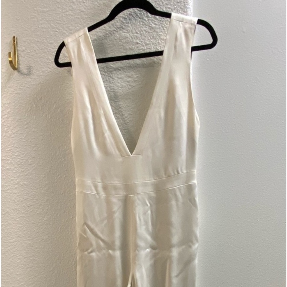 Vintage cream jumpsuit. Side zip, pockets. Deep V front and back, lined